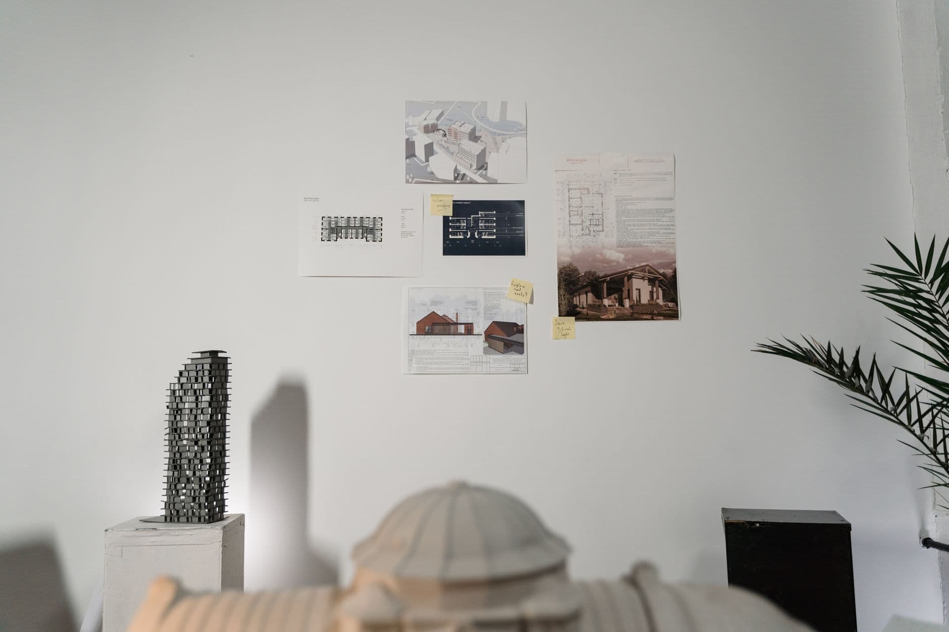 A creative architectural studio showcasing building plans and models in a modern indoor setting.