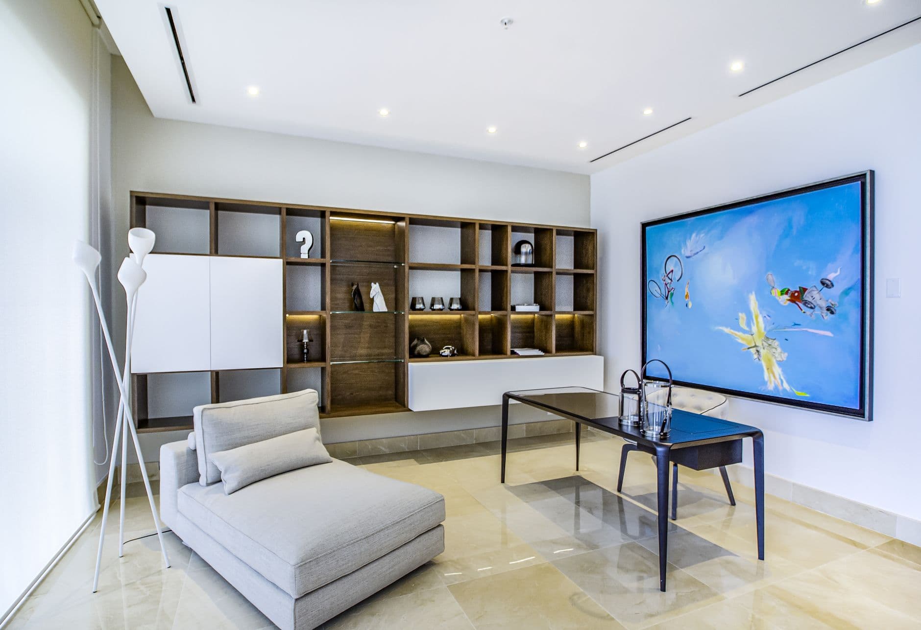 Sophisticated living room showcasing minimalist decor with abstract art and contemporary furniture.