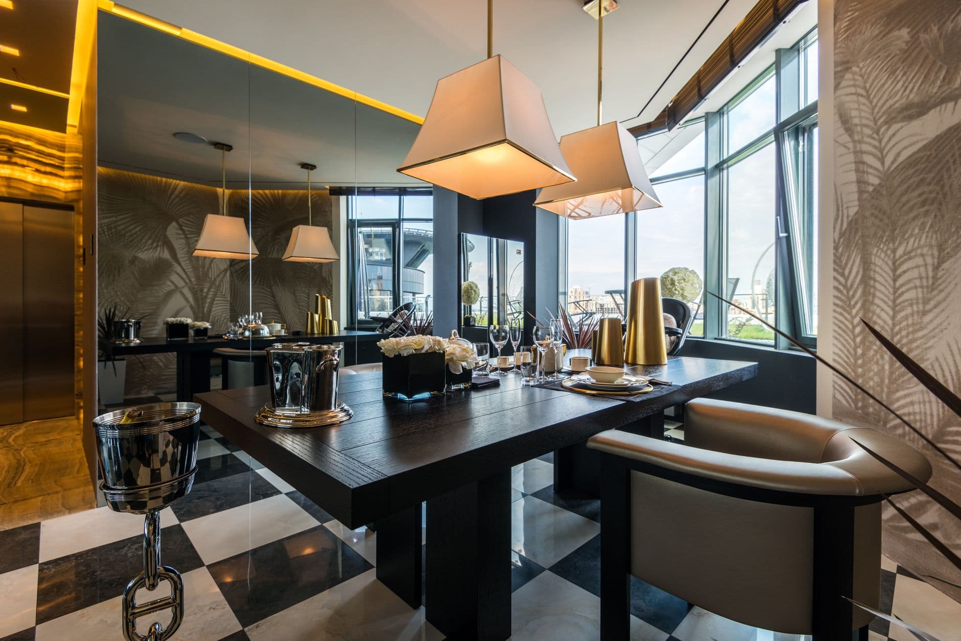 Modern dining room featuring elegant furniture, pendant lights, and large windows with city views.
